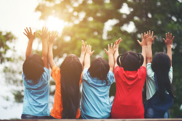 group-of-kids-friends-arm-around-sitting-together_1150-3907